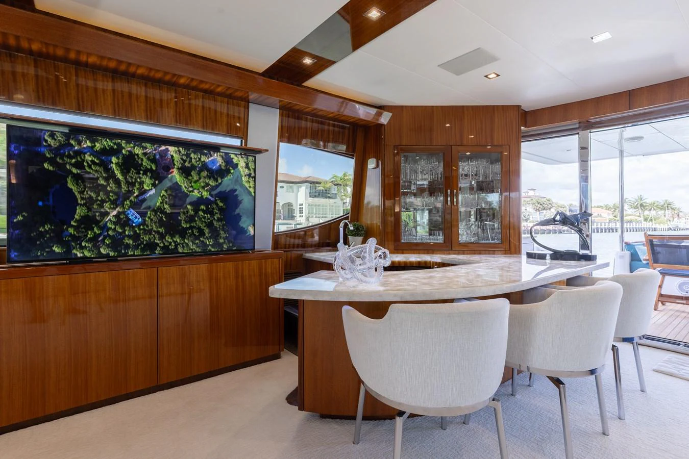 The salon features a sleek, modern design with a large TV and elegant dining area. aboard RITZ SEA Yacht for Sale