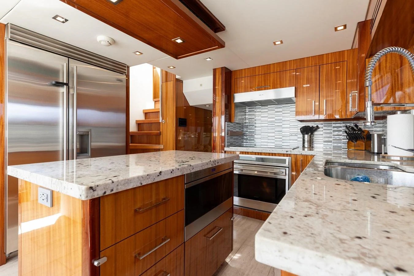 The yacht's galley features modern stainless steel appliances and luxurious wooden cabinetry. aboard RITZ SEA Yacht for Sale