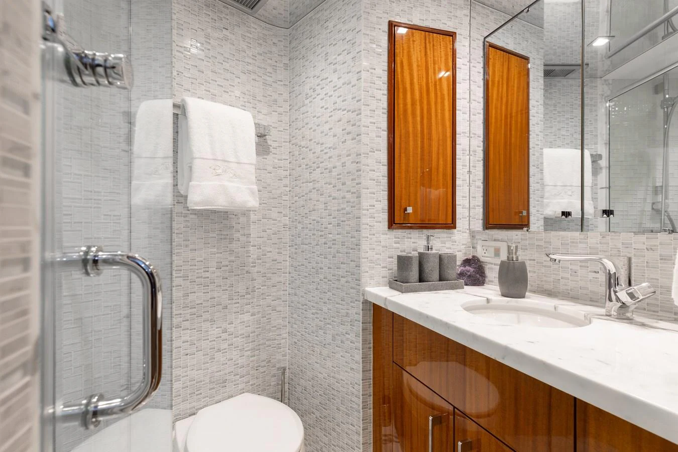 The yacht's bathroom features elegant wood cabinetry and modern fixtures. aboard RITZ SEA Yacht for Sale