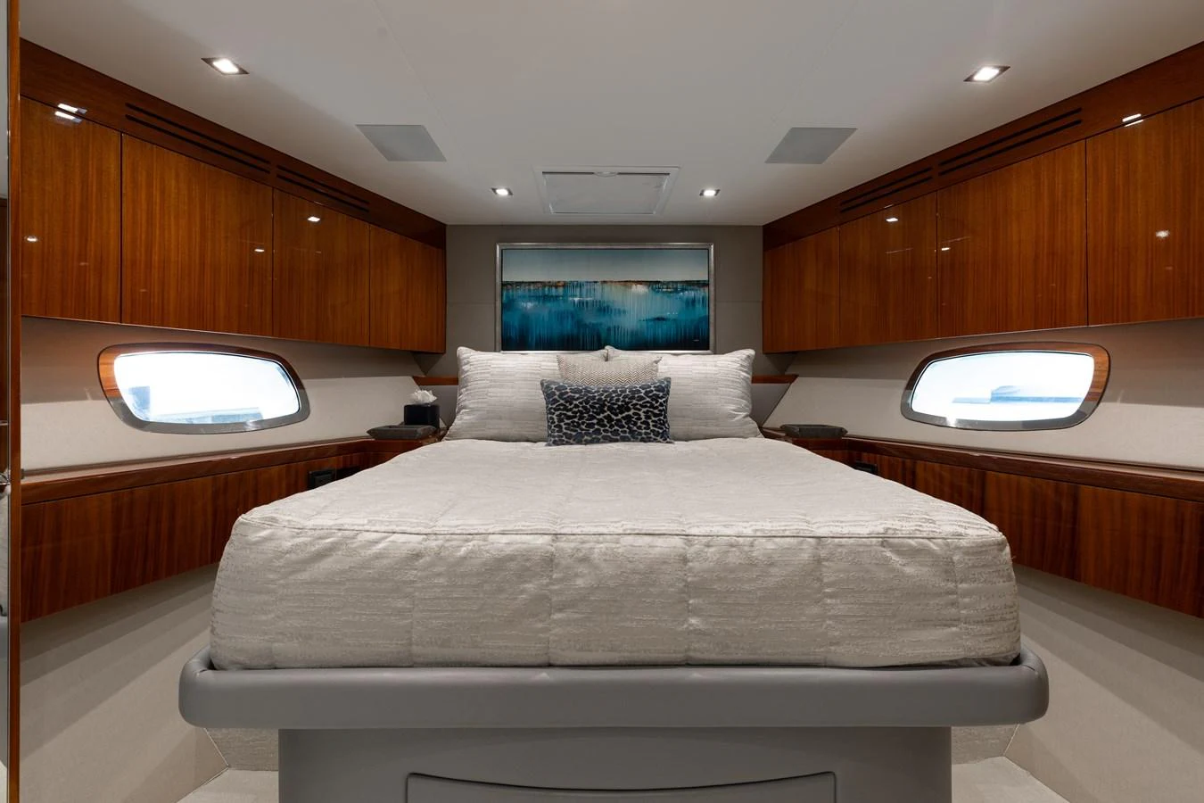 The stateroom features a plush bed with elegant wood paneling and ambient lighting. aboard RITZ SEA Yacht for Sale