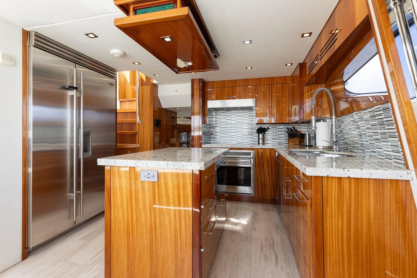 The yacht's galley features modern stainless steel appliances and elegant wooden cabinetry. aboard RITZ SEA Yacht for Sale