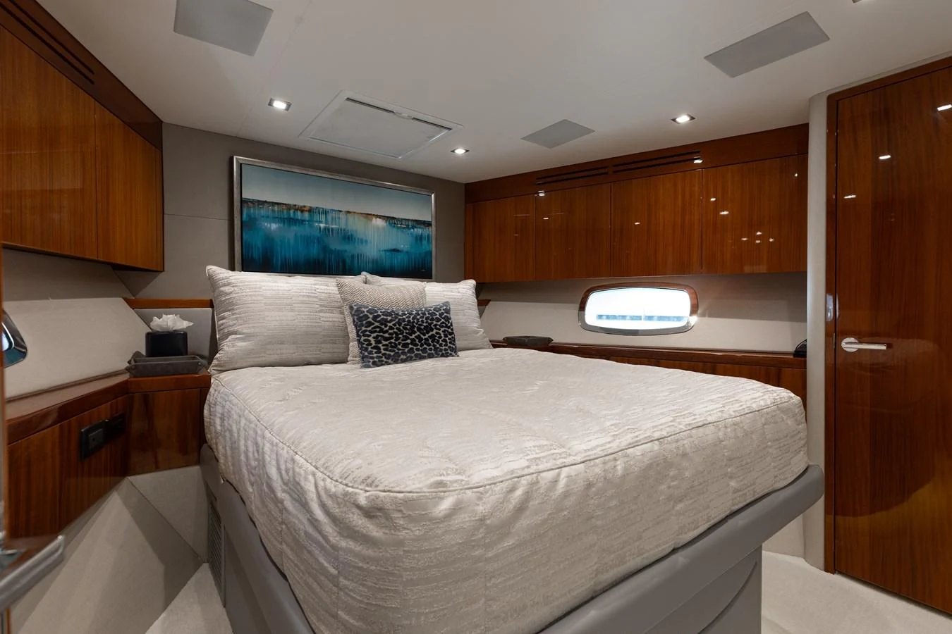 The stateroom features a plush bed with elegant wood finishes and modern lighting. aboard RITZ SEA Yacht for Sale