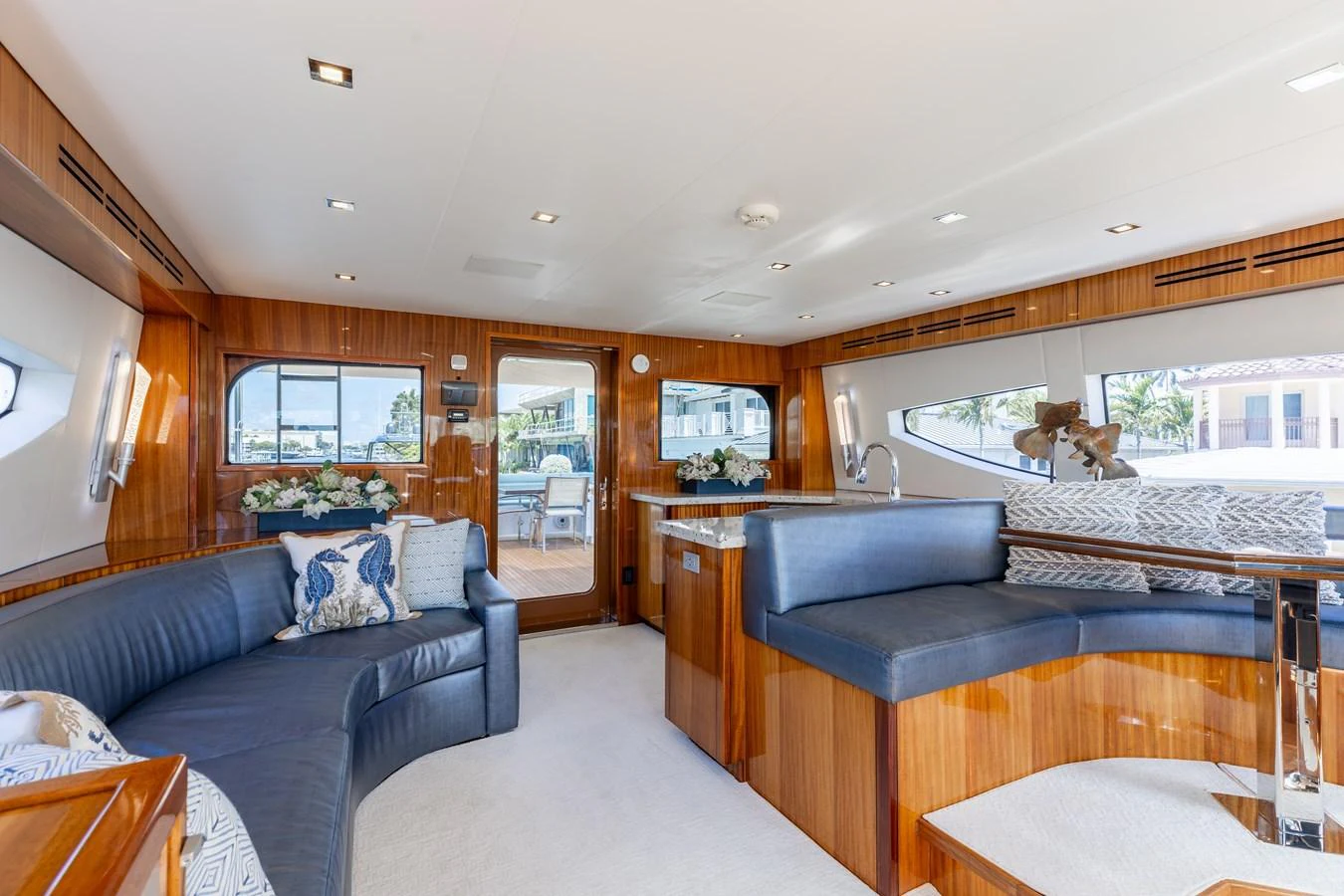The yacht's salon features elegant wood finishes, plush seating, and ample natural light. aboard RITZ SEA Yacht for Sale
