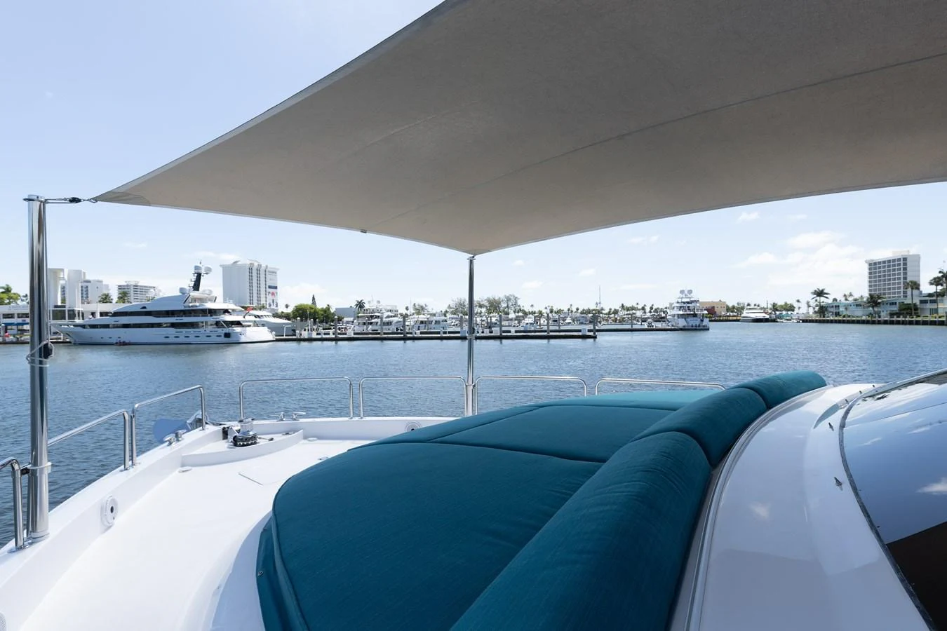 The flybridge offers a shaded lounging area with a view of the marina. aboard RITZ SEA Yacht for Sale