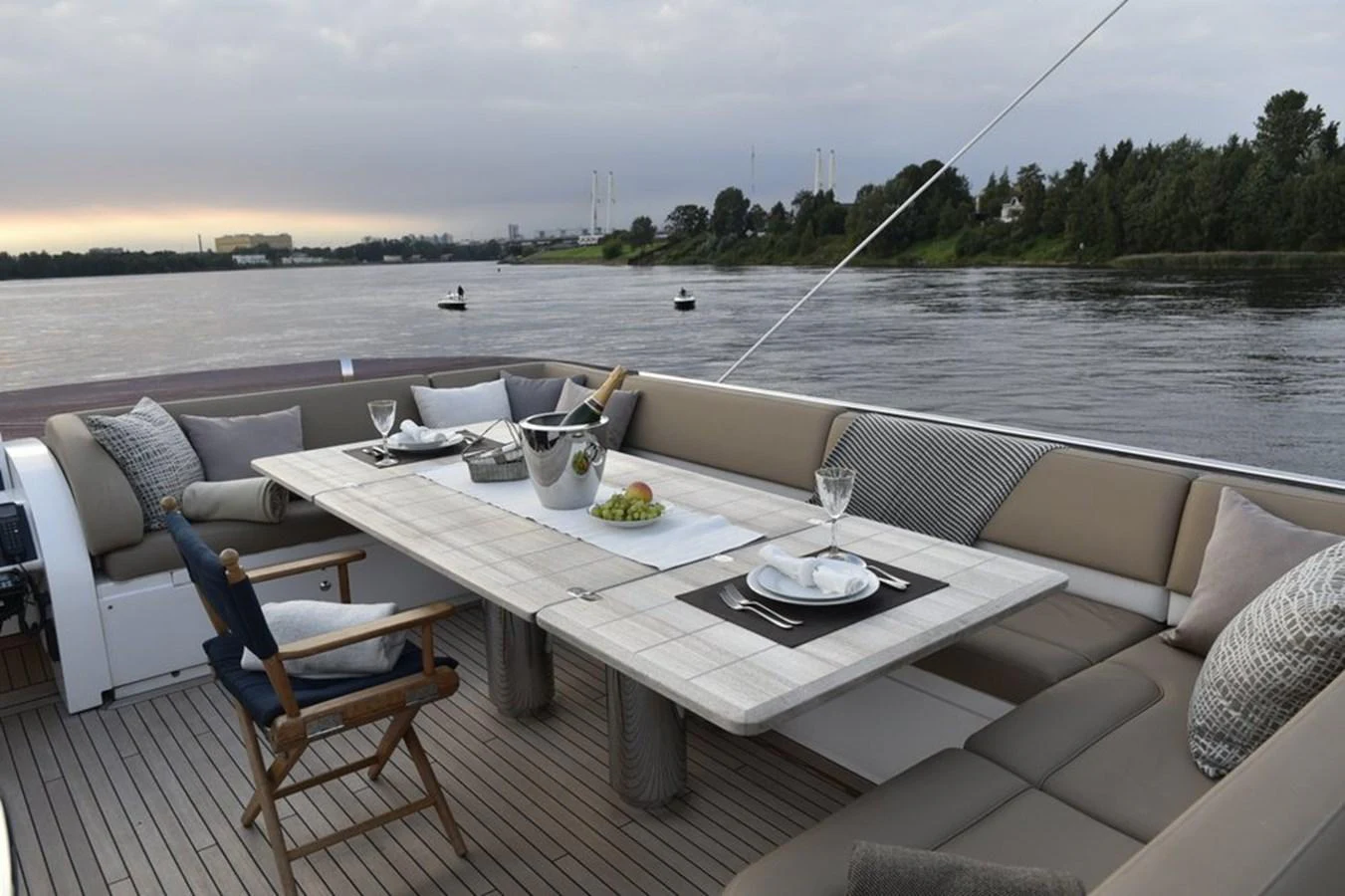 The aft deck features a stylish dining area with a large table and comfortable seating, perfect for alfresco meals. aboard KAZZA Yacht for Sale