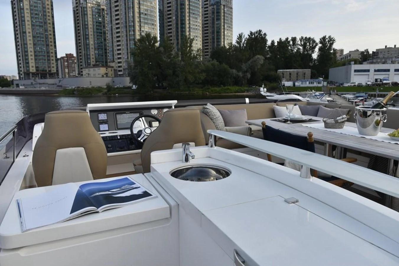 The flybridge offers a luxurious outdoor space with comfortable seating and a well-equipped helm station. aboard KAZZA Yacht for Sale