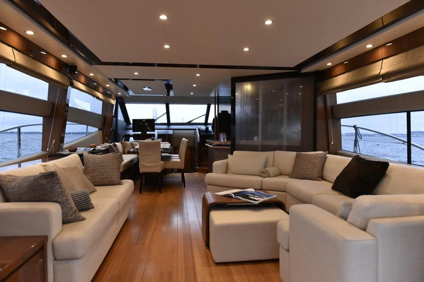 The salon offers a spacious and elegant seating area with panoramic views. aboard KAZZA Yacht for Sale