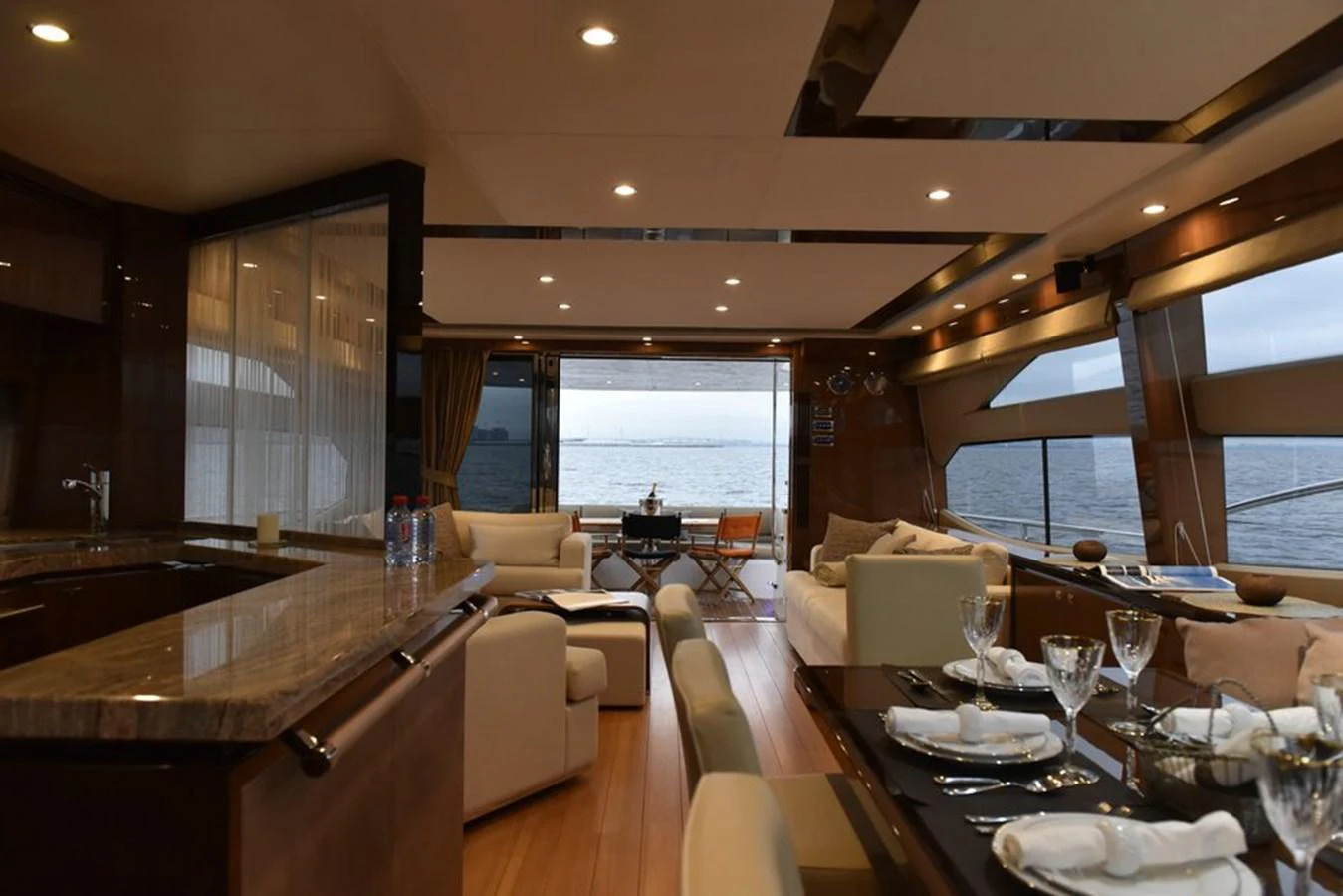 The salon offers a luxurious and spacious area with elegant furnishings and a stunning view of the sea. aboard KAZZA Yacht for Sale