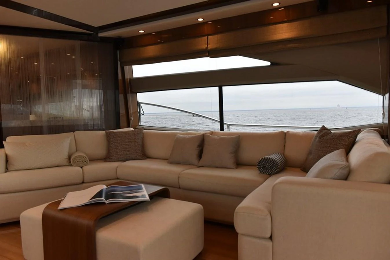 The salon features a spacious and comfortable seating area with a view of the sea. aboard KAZZA Yacht for Sale