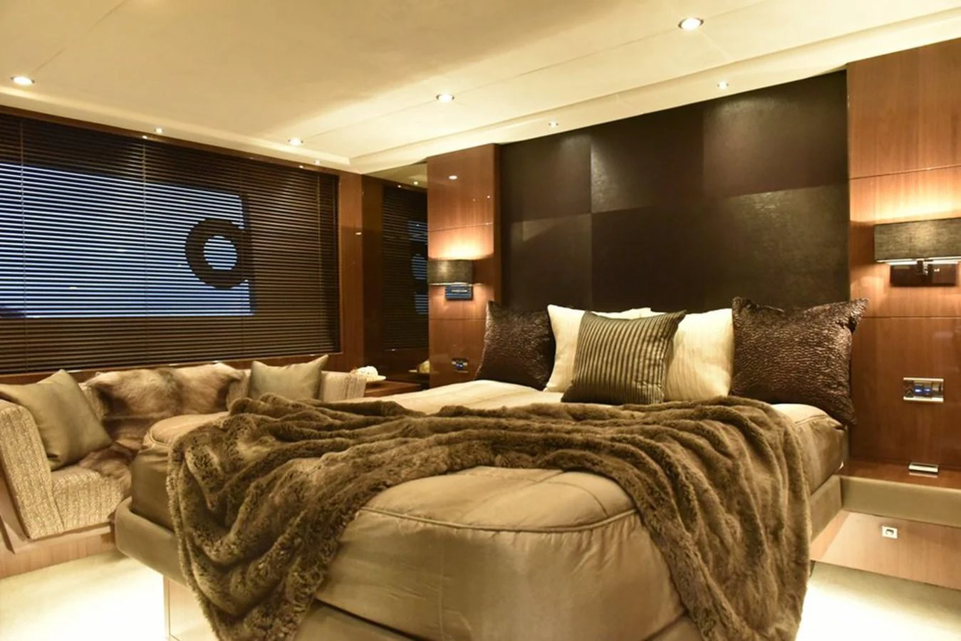 The master stateroom exudes luxury with its plush bedding and warm lighting. aboard KAZZA Yacht for Sale