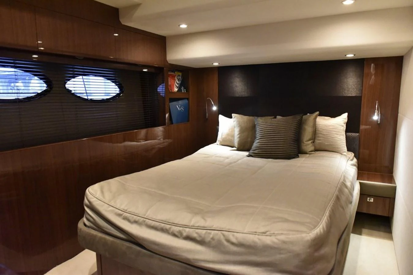 A cozy and elegant stateroom featuring a plush bed and warm lighting. aboard KAZZA Yacht for Sale