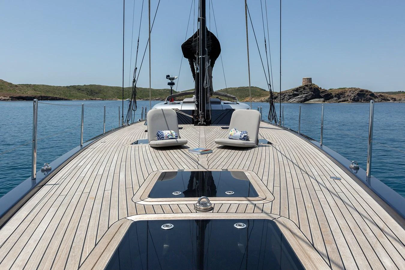 The foredeck of the yacht features sleek wooden decking and comfortable seating with scenic views. aboard CAIAROSSA Yacht for Sale