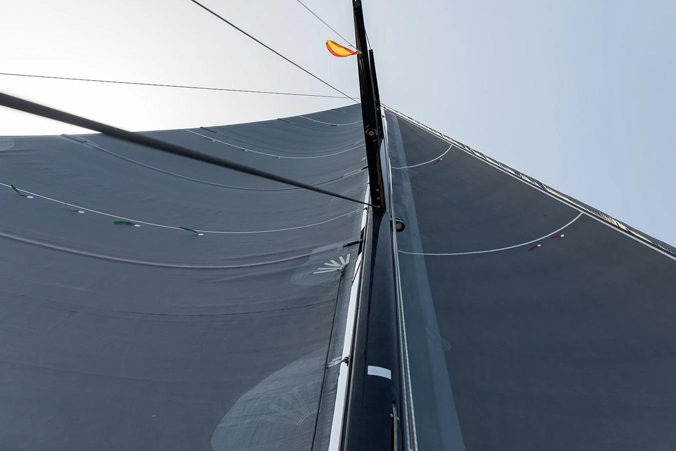 A close-up view of the yacht's sail and mast, showcasing the rigging and sail material. aboard CAIAROSSA Yacht for Sale