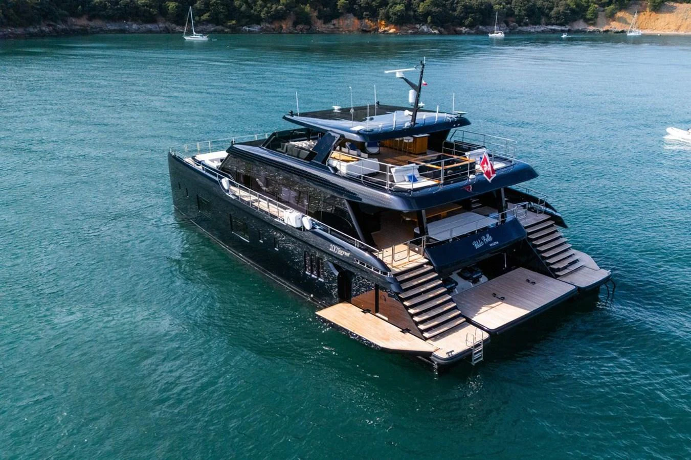 A sleek and modern yacht cruising on calm waters with a spacious aft deck and luxurious amenities. aboard PETITE BELLE Yacht for Sale