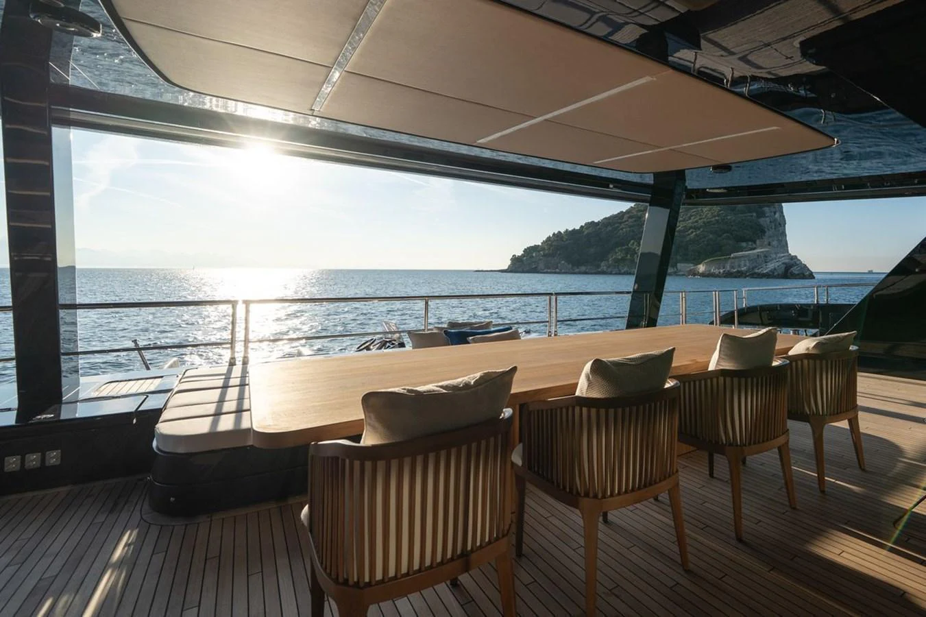 The aft deck features a spacious dining area with a stunning ocean view. aboard PETITE BELLE Yacht for Sale