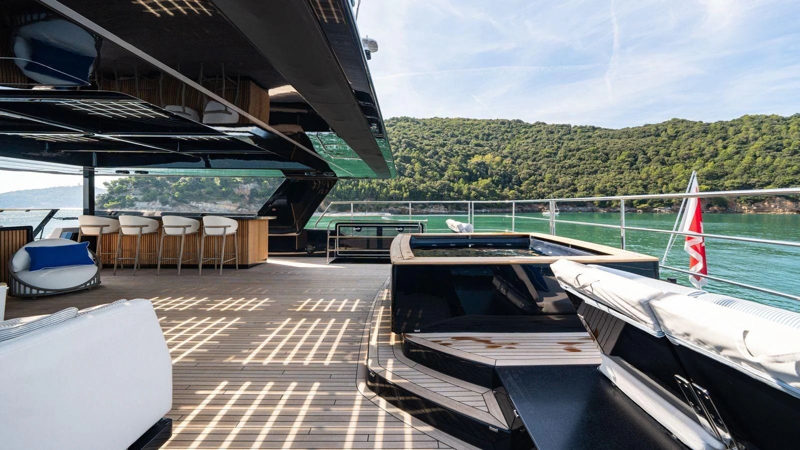 The yacht's aft deck offers a luxurious outdoor space with ample seating and stunning views. aboard PETITE BELLE Yacht for Sale