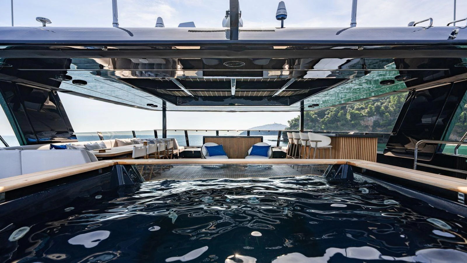 The sundeck features a luxurious pool with stunning views of the surrounding seascape. aboard PETITE BELLE Yacht for Sale