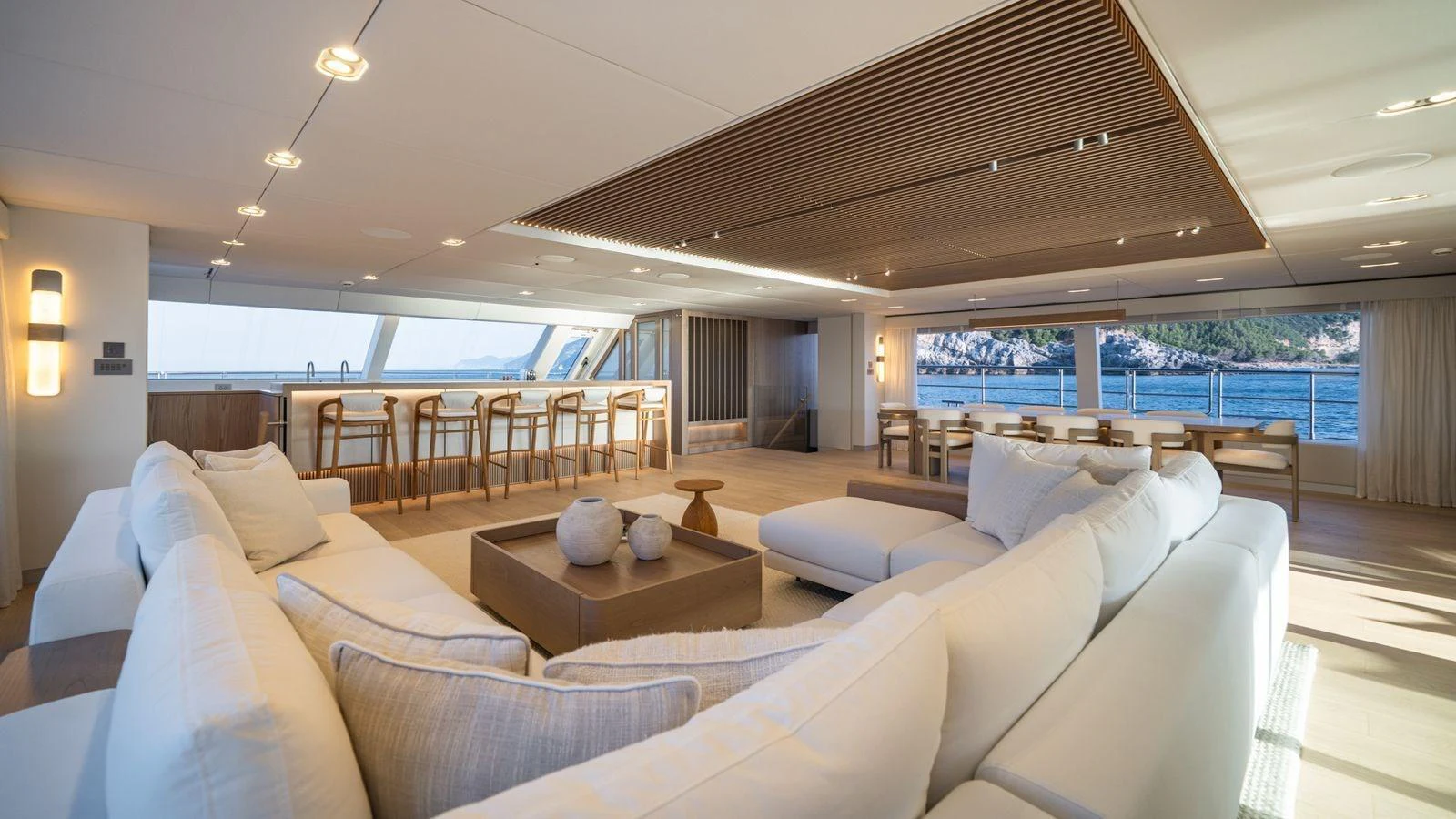 The spacious salon features elegant seating and expansive windows offering stunning views. aboard PETITE BELLE Yacht for Sale