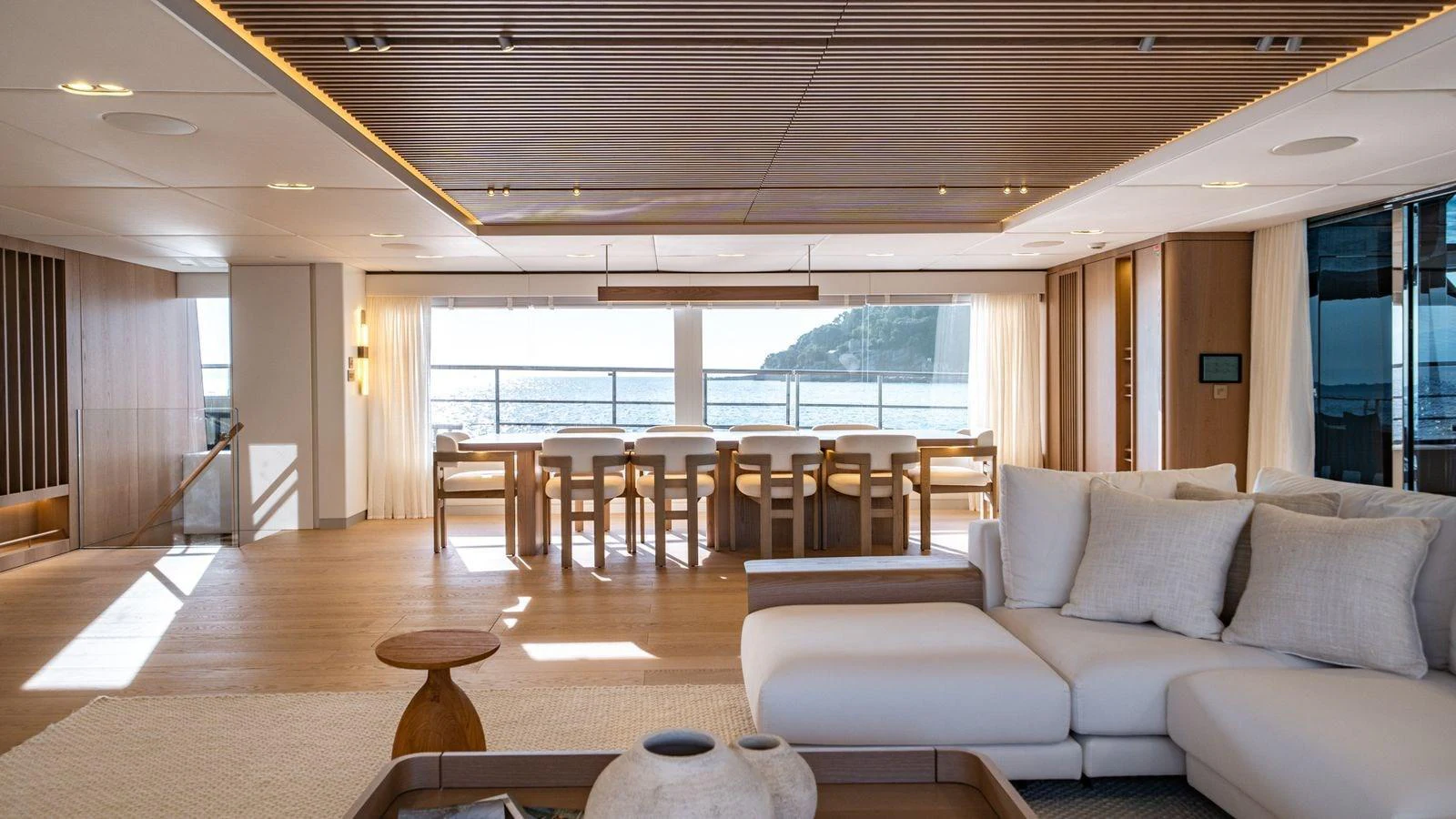The salon features a spacious and elegantly designed seating area with panoramic ocean views. aboard PETITE BELLE Yacht for Sale