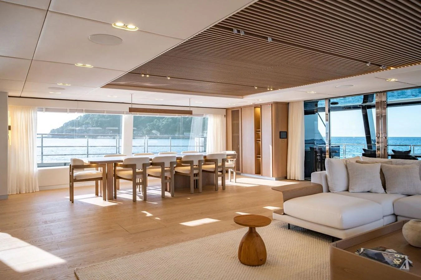 The spacious salon features elegant furnishings and large windows offering stunning sea views. aboard PETITE BELLE Yacht for Sale