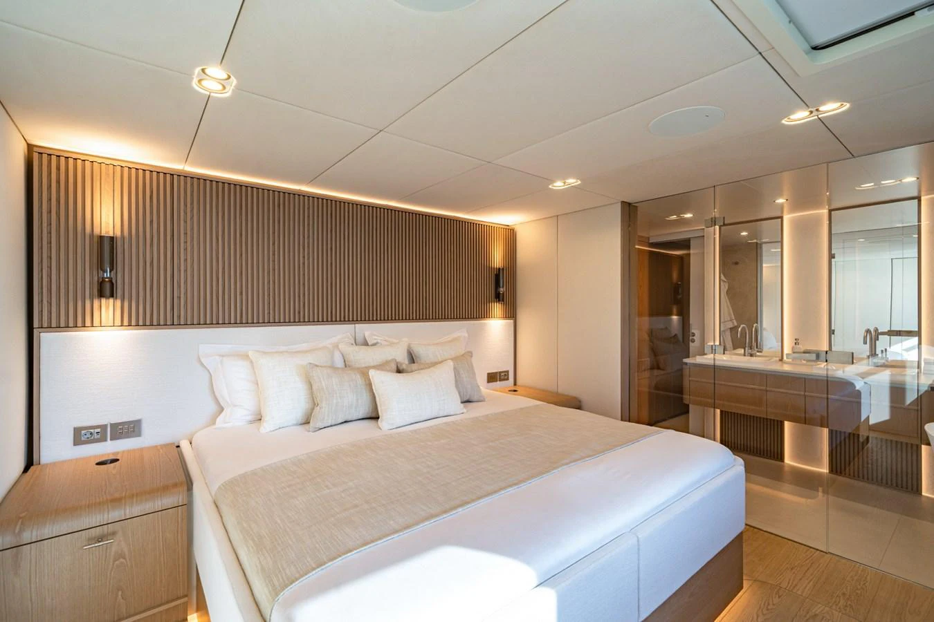The master stateroom features a luxurious bed with elegant lighting and ample storage space. aboard PETITE BELLE Yacht for Sale