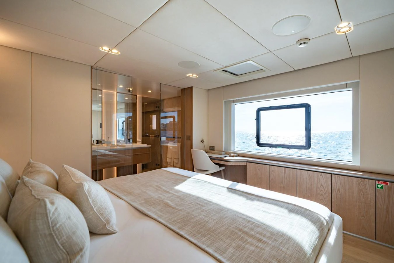 A serene stateroom with a large bed, ample natural light, and a view of the sea. aboard PETITE BELLE Yacht for Sale