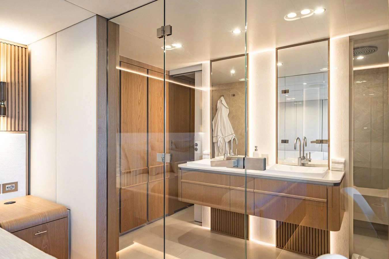 The yacht's bathroom features a modern design with dual sinks and ample lighting. aboard PETITE BELLE Yacht for Sale