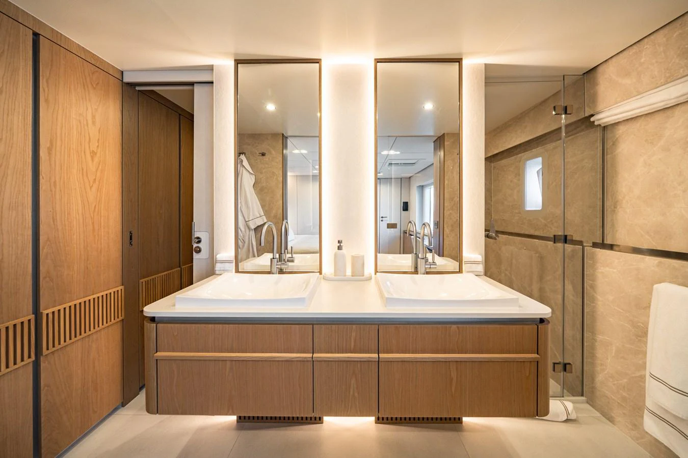 The yacht's bathroom features a modern design with dual sinks and ample storage. aboard PETITE BELLE Yacht for Sale