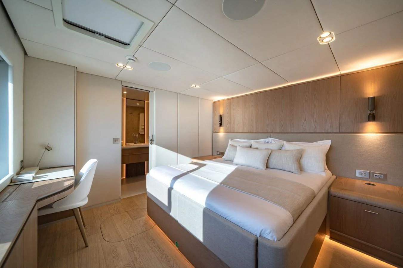 The master stateroom features a spacious bed, modern furnishings, and ample natural light. aboard PETITE BELLE Yacht for Sale