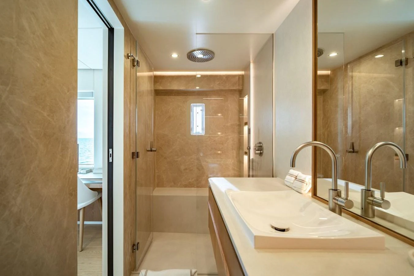 A luxurious yacht bathroom featuring elegant marble finishes and modern fixtures. aboard PETITE BELLE Yacht for Sale
