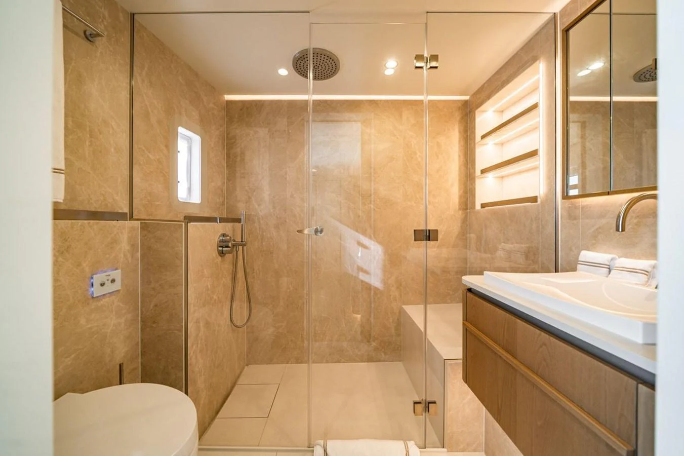 The yacht's bathroom features a sleek, modern design with glass-enclosed shower and elegant fixtures. aboard PETITE BELLE Yacht for Sale
