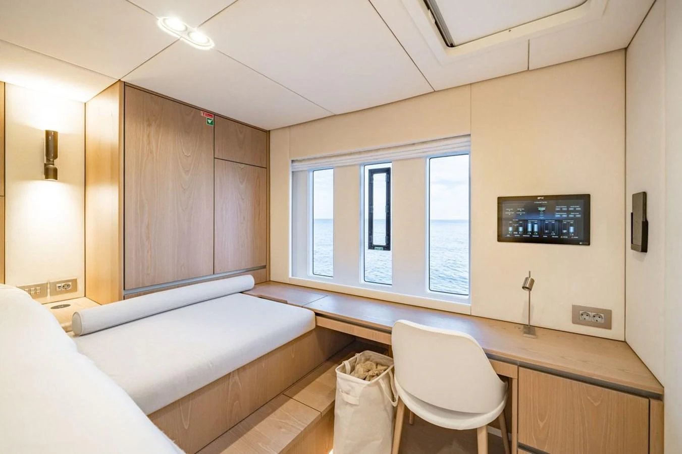 A serene cabin with a large window offering a view of the sea. aboard PETITE BELLE Yacht for Sale
