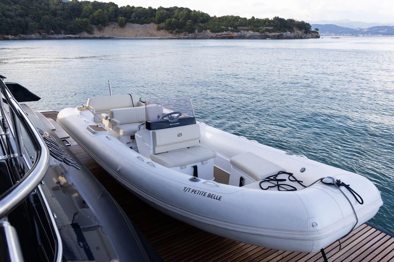 A sleek tender is docked beside the yacht, ready for excursions. aboard PETITE BELLE Yacht for Sale