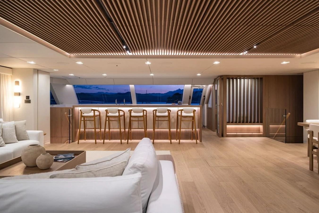 The yacht's interior features a spacious and elegantly designed lounge area with modern furnishings. aboard PETITE BELLE Yacht for Sale