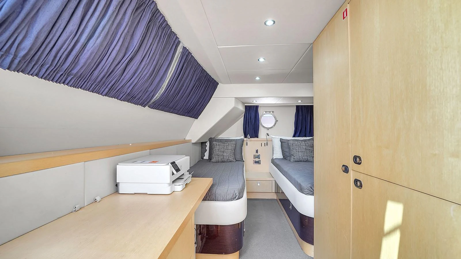a room with a bed and a desk aboard M4 Yacht for Sale