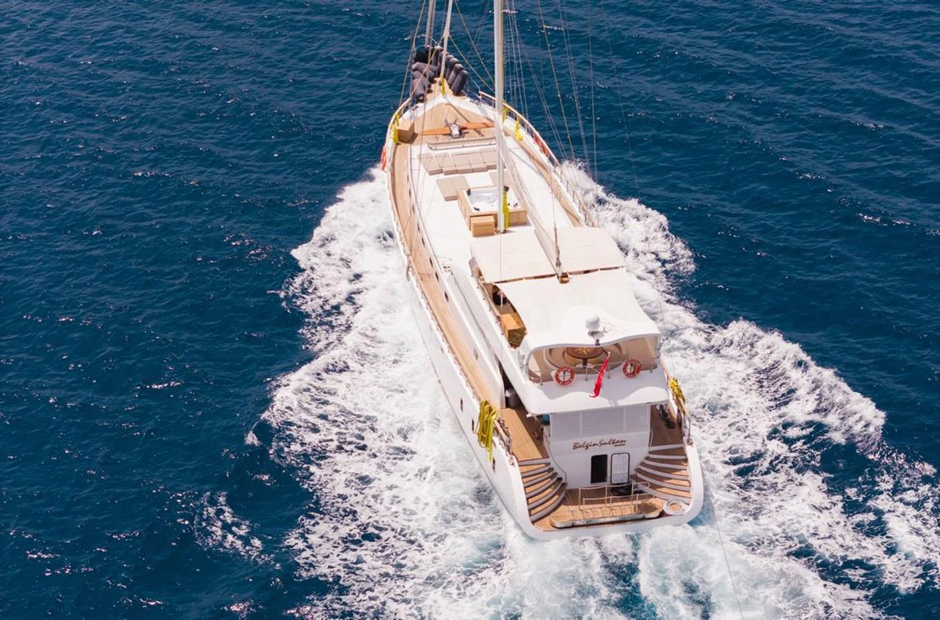 A luxurious yacht sails smoothly through the open sea, showcasing its elegant design and spacious deck. aboard BELGIN SULTAN Yacht for Sale