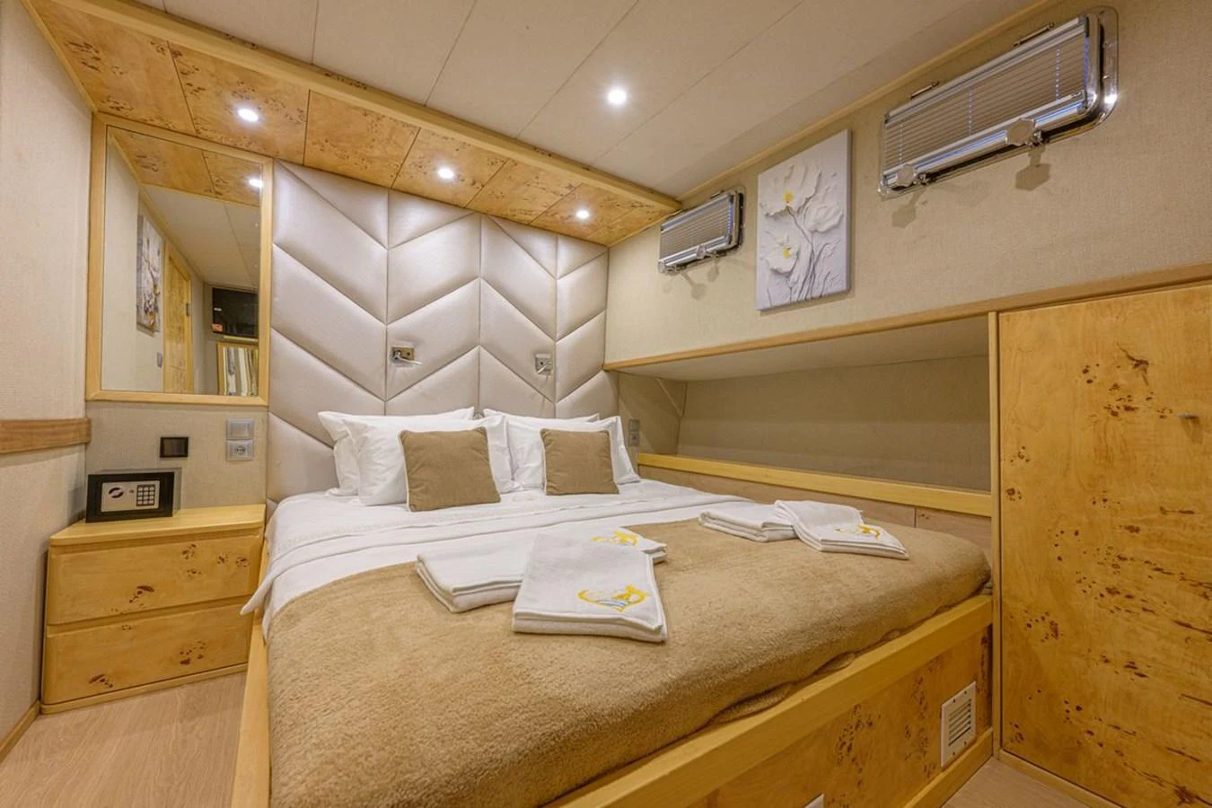 The stateroom features a plush bed with elegant bedding and warm wooden accents, creating a cozy and inviting atmosphere. aboard BELGIN SULTAN Yacht for Sale