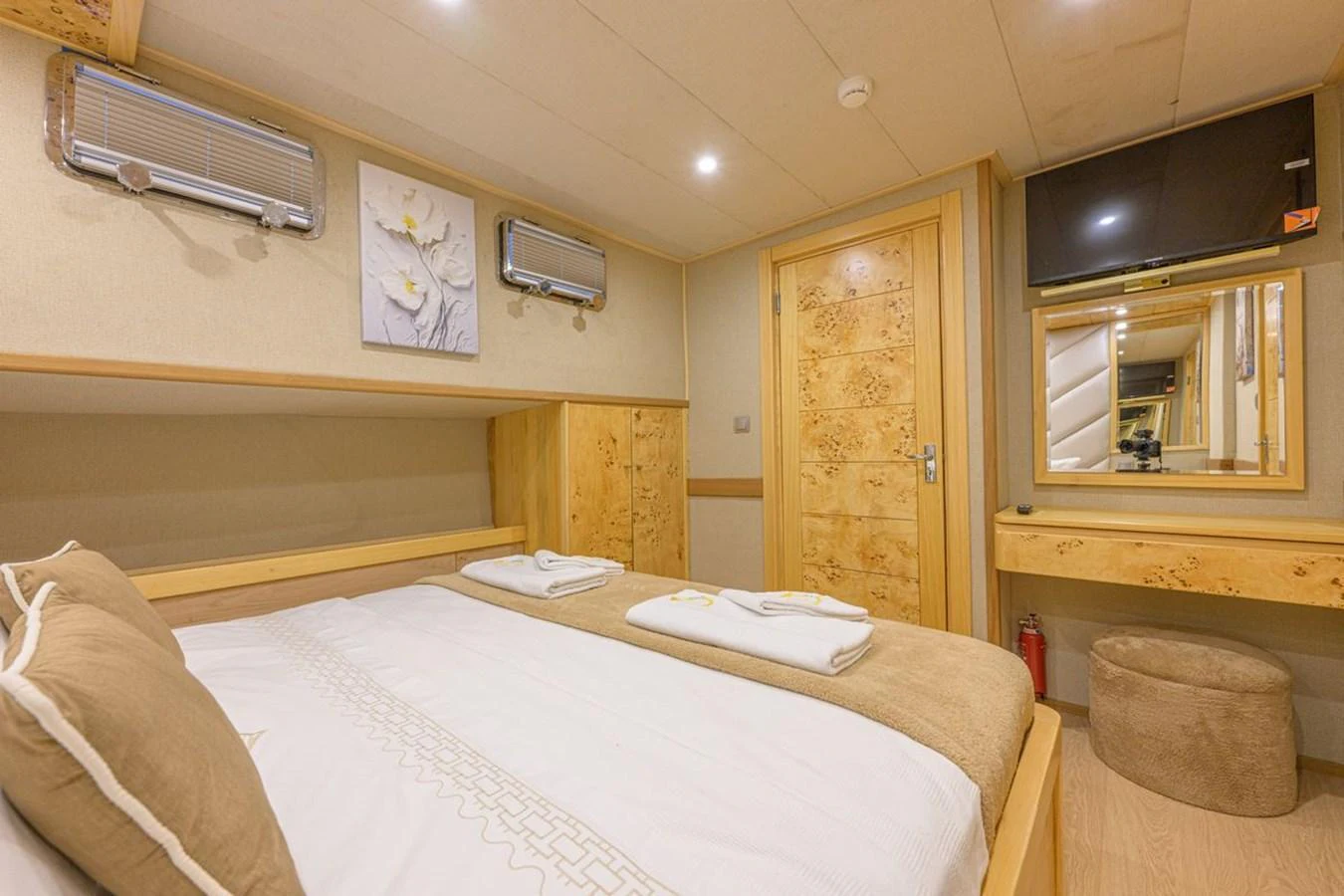 A cozy stateroom featuring a comfortable bed, wooden accents, and modern amenities. aboard BELGIN SULTAN Yacht for Sale