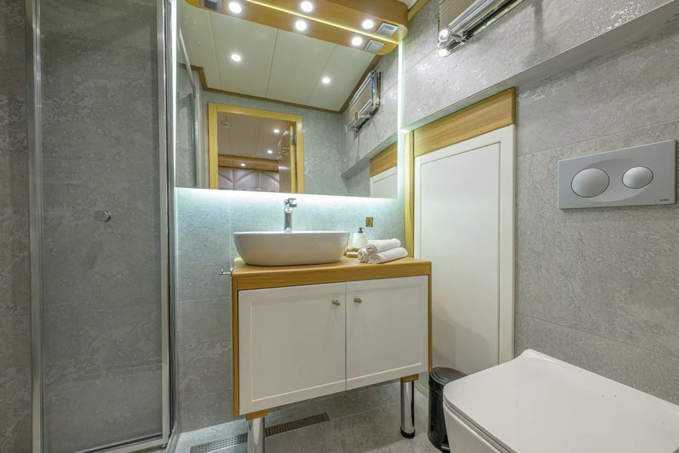 A modern yacht bathroom featuring a sleek vanity and a spacious shower. aboard BELGIN SULTAN Yacht for Sale
