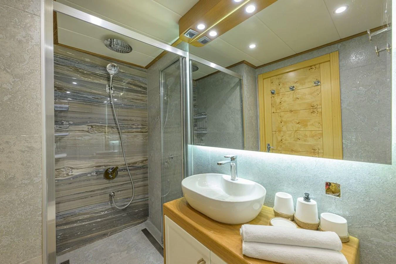 The yacht's bathroom features a modern shower and sleek vanity area. aboard BELGIN SULTAN Yacht for Sale
