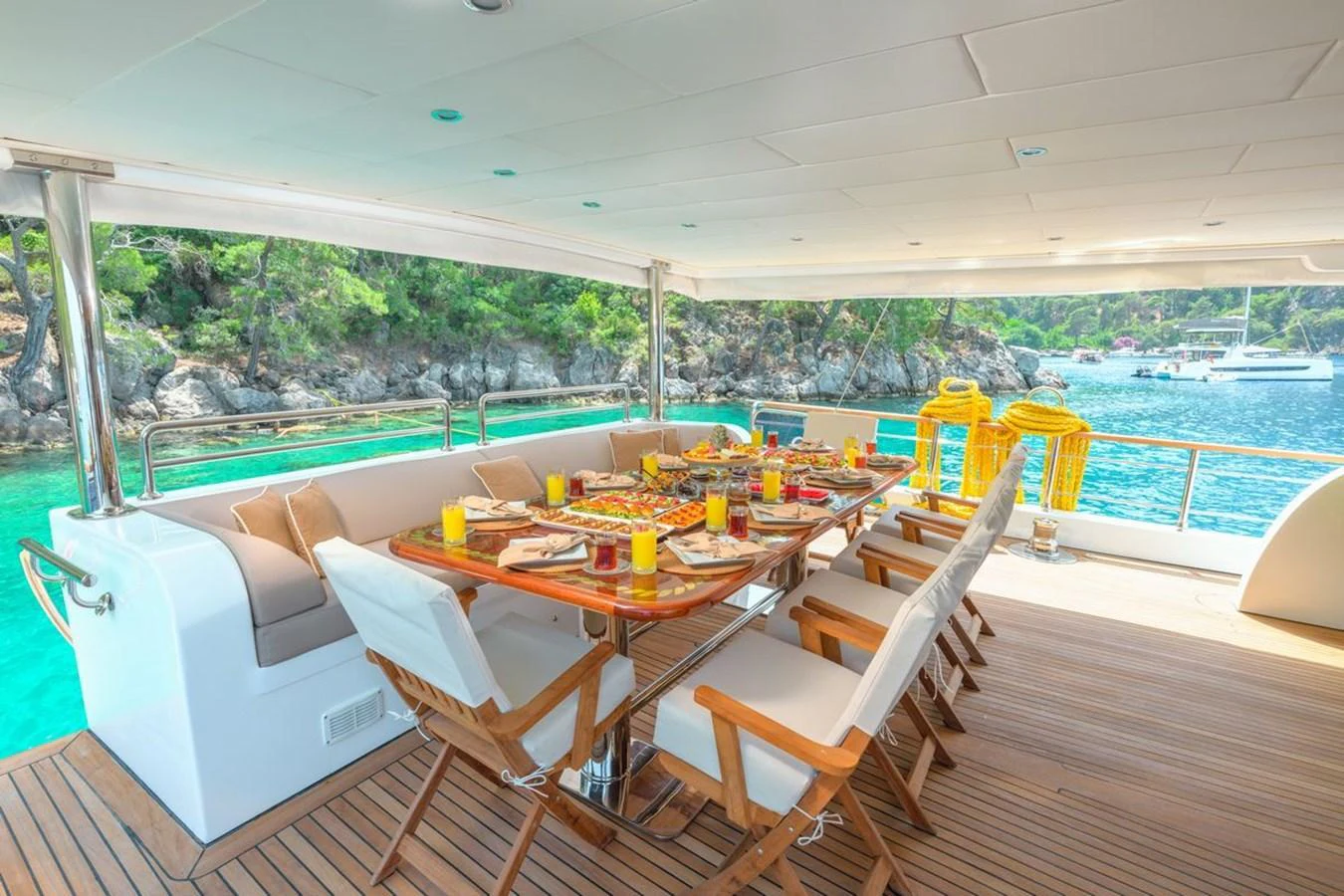 The aft deck features an elegant dining area with a stunning view of the surrounding waters. aboard BELGIN SULTAN Yacht for Sale