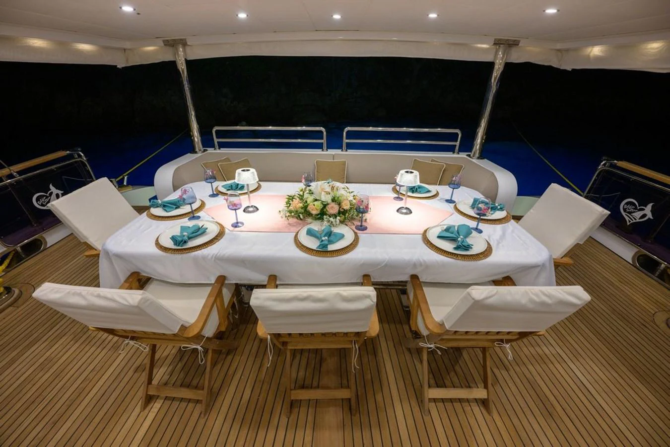 The aft deck features an elegant dining setup with a beautifully arranged table and comfortable seating. aboard BELGIN SULTAN Yacht for Sale