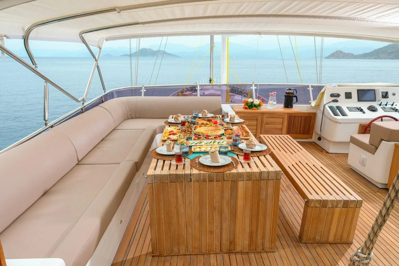 The flybridge offers a luxurious dining area with stunning ocean views. aboard BELGIN SULTAN Yacht for Sale