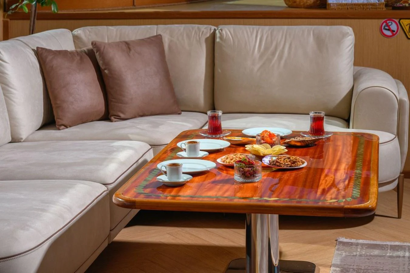 The salon features a cozy seating area with a wooden table set for refreshments. aboard BELGIN SULTAN Yacht for Sale