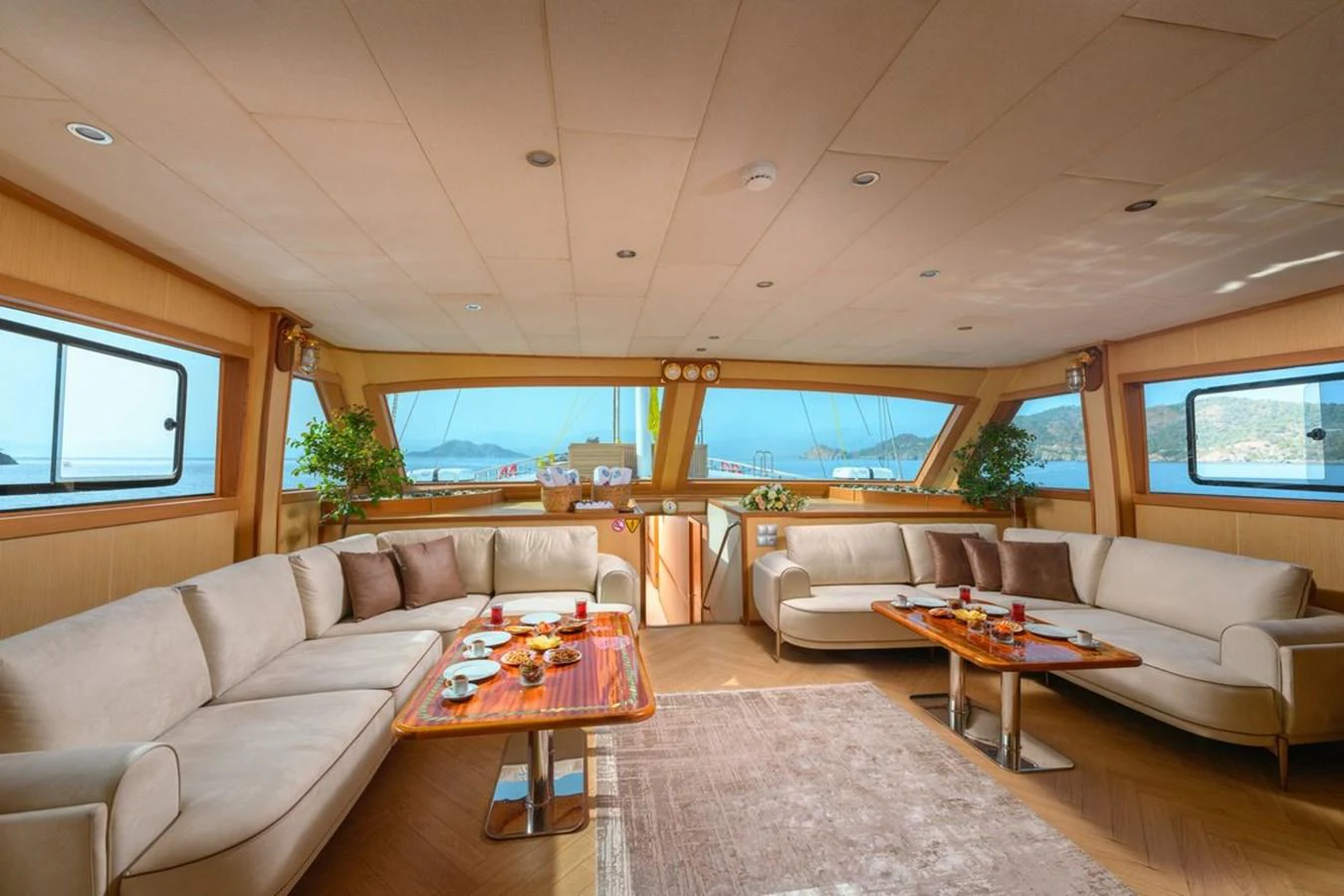 The spacious salon features comfortable seating and panoramic windows offering stunning views. aboard BELGIN SULTAN Yacht for Sale