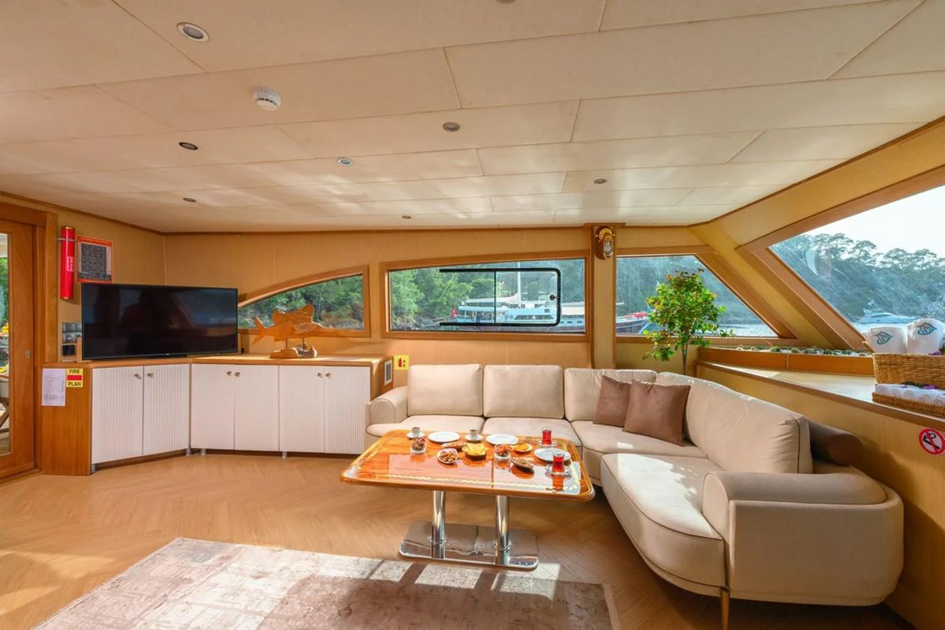 The salon offers a cozy and inviting space with a comfortable seating area and large windows providing scenic views. aboard BELGIN SULTAN Yacht for Sale