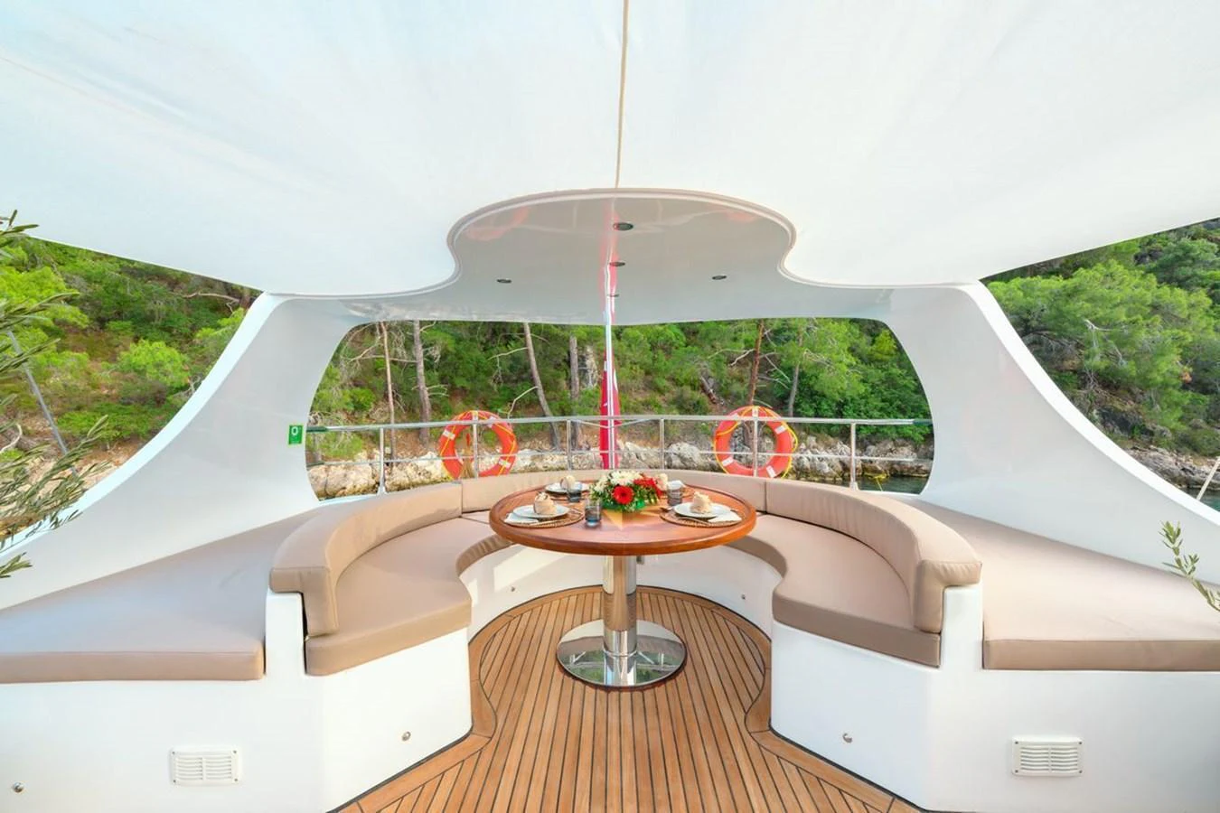 This inviting alfresco dining area offers a serene setting for meals with a view of lush greenery. aboard BELGIN SULTAN Yacht for Sale