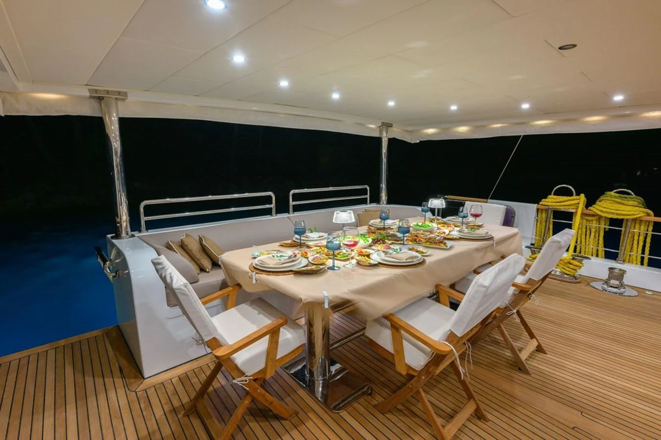 The aft deck features an elegant dining setup with a beautifully arranged table, perfect for alfresco dining. aboard BELGIN SULTAN Yacht for Sale