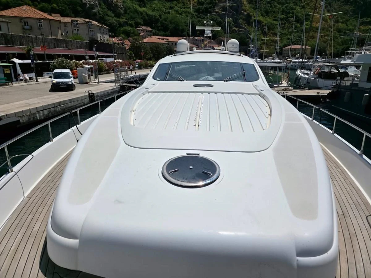 The yacht's bow area is shown docked at a marina, featuring a sleek and modern design. aboard EVASIONE Yacht for Sale