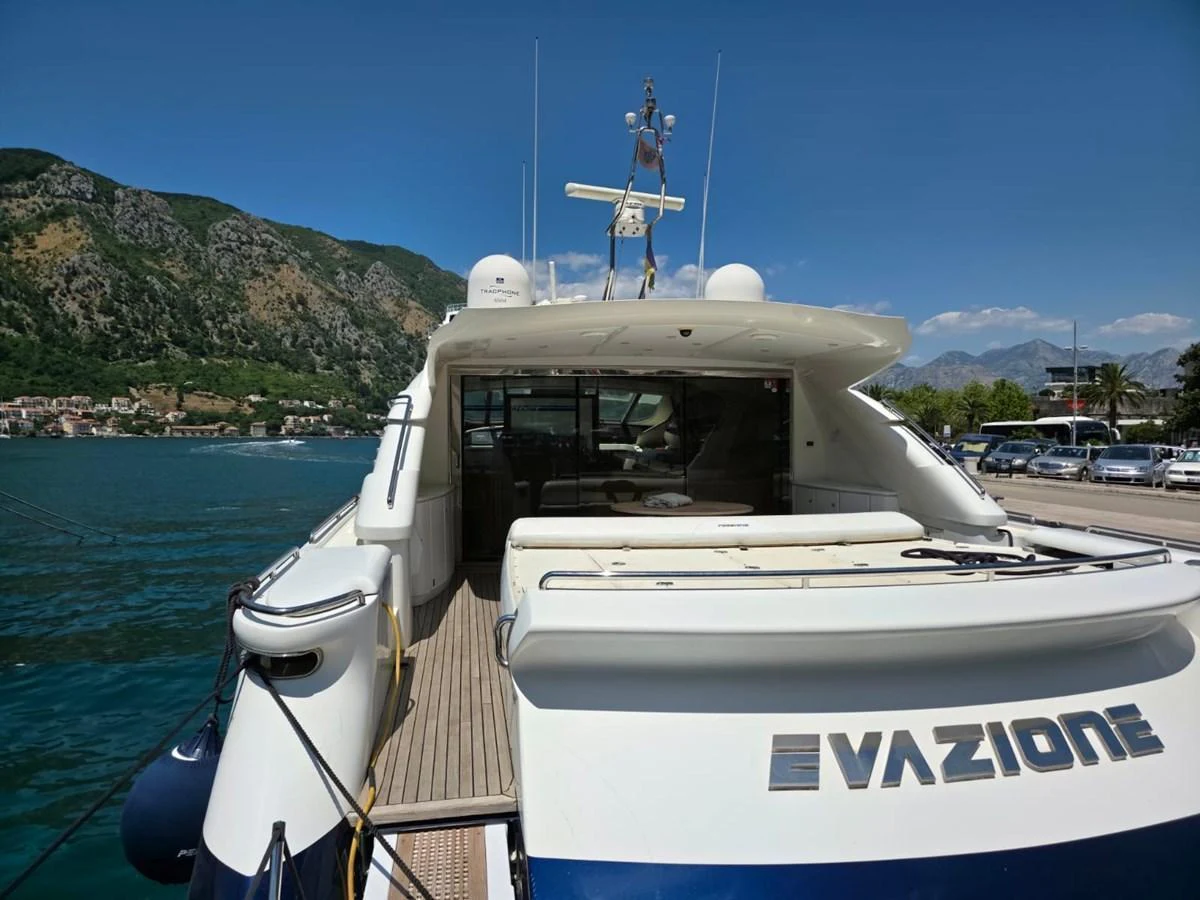 The yacht's aft deck offers a spacious and inviting area for relaxation and socializing, with scenic views of the surrounding landscape. aboard EVASIONE Yacht for Sale